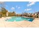 Large community pool with a spacious deck area, umbrellas, and landscaping at 571 Rough Hewn Ln, Rock Hill, SC 29730