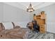 Cozy office space featuring tray ceiling, decorative lighting, hardwood floors and modern furnishings at 571 Rough Hewn Ln, Rock Hill, SC 29730
