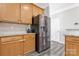 Bright kitchen with stainless steel refrigerator, granite countertops and wood cabinets at 571 Rough Hewn Ln, Rock Hill, SC 29730