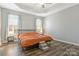 Large bedroom with modern wood floors, neutral paint, and ample natural light through the windows at 571 Rough Hewn Ln, Rock Hill, SC 29730