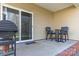 Cozy back patio with table, chairs, sliding glass door, and grill with a brick base at 571 Rough Hewn Ln, Rock Hill, SC 29730