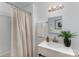 Well-lit bathroom featuring a modern vanity, framed mirror, and stylish shower curtain at 5825 Greene St, Charlotte, NC 28269