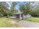 Charming single-story home with a gravel driveway and covered front porch with rocking chairs at 5825 Greene St, Charlotte, NC 28269
