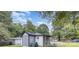 Quaint home exterior with gray siding, new roof, and partially fenced yard at 5825 Greene St, Charlotte, NC 28269