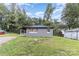 Charming single-story home with fresh landscaping, front porch and updated gray siding at 5825 Greene St, Charlotte, NC 28269