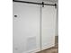Bright hallway with a sliding barn door with white walls and hardwood floors at 5825 Greene St, Charlotte, NC 28269