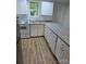 Bright kitchen with stainless steel appliances, white cabinets, and granite countertops at 5825 Greene St, Charlotte, NC 28269