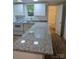 Bright kitchen with stainless steel appliances, white cabinets, granite countertops, and hardwood floors at 5825 Greene St, Charlotte, NC 28269