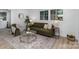 Inviting living room featuring large windows, modern décor, and stylish flooring at 5825 Greene St, Charlotte, NC 28269