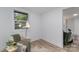 Bright living room with stylish chair, lamp, and view to the front yard at 5825 Greene St, Charlotte, NC 28269