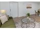 Cozy living area featuring modern décor, a large glass coffee table, and hardwood floors at 5825 Greene St, Charlotte, NC 28269
