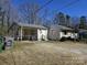 View of the back exterior, carport and partially fenced-in yard at 5924 Freedom Dr, Charlotte, NC 28214