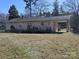 Back exterior of home with spacious backyard and wooden deck at 5924 Freedom Dr, Charlotte, NC 28214
