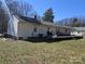 Backyard view with deck, barbecue grill, and mature trees, ideal for entertaining at 5924 Freedom Dr, Charlotte, NC 28214
