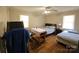 Bedroom featuring 2 beds, 2 windows, and hardwood floors at 5924 Freedom Dr, Charlotte, NC 28214