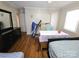 Bedroom featuring a dresser, treadmill, hardwood floors, and neutral color scheme at 5924 Freedom Dr, Charlotte, NC 28214
