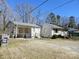 Quaint single-story home featuring a carport and partially fenced yard at 5924 Freedom Dr, Charlotte, NC 28214