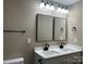 Contemporary bathroom featuring a double vanity with sleek black faucets, dual mirrors, and modern lighting fixtures at 6756 Denver Heights Cir, Denver, NC 28037