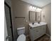 Bathroom featuring double sink vanity, wood look floors and modern fixtures at 6756 Denver Heights Cir, Denver, NC 28037