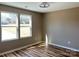 Bedroom with ample natural light streaming through two windows, highlighting the room's hardwood floors and neutral color scheme at 6756 Denver Heights Cir, Denver, NC 28037