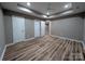 Spacious bedroom featuring wood-look flooring, recessed lighting, and a tray ceiling with a ceiling fan at 6756 Denver Heights Cir, Denver, NC 28037