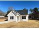 Beautiful exterior shot of a well-maintained house, featuring white siding, complemented by a pristine lawn and clear blue skies at 6756 Denver Heights Cir, Denver, NC 28037