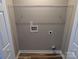 Interior view of a functional laundry room area ready for appliances, featuring clean lines and hardwood floors at 6756 Denver Heights Cir, Denver, NC 28037