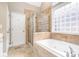 Luxurious bathroom with a soaking tub, glass shower, and large window at 7006 Waggoners Glen Ln, Charlotte, NC 28226