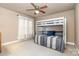 Cozy bedroom featuring a bunk bed with gray and white striped bedding and a ceiling fan at 7006 Waggoners Glen Ln, Charlotte, NC 28226