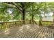 Spacious wooden deck offering an outdoor living area with views of the backyard and mature trees at 7770 Sherrills Ford Rd, Sherrills Ford, NC 28673