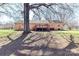 View of the home's backyard, featuring a large tree providing ample shade and a cozy outdoor living space at 7770 Sherrills Ford Rd, Sherrills Ford, NC 28673