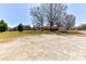 Large backyard with mature trees surrounding the home, providing shade and outdoor space at 7770 Sherrills Ford Rd, Sherrills Ford, NC 28673