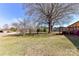 Expansive backyard offers mature trees with large shade canopy and a wooden deck accessible from the home at 7770 Sherrills Ford Rd, Sherrills Ford, NC 28673