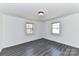 Empty bedroom with new gray floors and two windows that offer ample natural light at 7770 Sherrills Ford Rd, Sherrills Ford, NC 28673