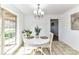 Cozy dining area with a chandelier and a view of the backyard through a large window at 7770 Sherrills Ford Rd, Sherrills Ford, NC 28673
