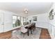 Sunlit dining room features hardwood floors, a large window, and classic furnishings, ready for entertaining at 7770 Sherrills Ford Rd, Sherrills Ford, NC 28673