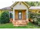 Inviting front porch with classic brick steps, white columns, and decorative door with sidelight windows at 7770 Sherrills Ford Rd, Sherrills Ford, NC 28673