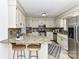 Well-equipped kitchen with stainless steel appliances, granite countertops, and bar seating for casual dining at 7770 Sherrills Ford Rd, Sherrills Ford, NC 28673