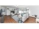 Bright living room with a painted brick fireplace, hardwood floors and plentiful natural light from large windows at 7770 Sherrills Ford Rd, Sherrills Ford, NC 28673