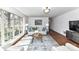 Spacious living room with a large window, hardwood floors, comfortable seating, and stylish decor at 7770 Sherrills Ford Rd, Sherrills Ford, NC 28673