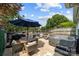 A spacious backyard with a hot tub, dining set, barbecue grill, and manicured artificial grass at 8123 Village Harbor Dr, Cornelius, NC 28031