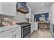 Modern kitchen showcasing white cabinets, marble countertops, and stainless steel appliances at 8123 Village Harbor Dr, Cornelius, NC 28031