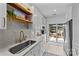 Bright kitchen featuring white cabinets, marble countertops, and stainless steel appliances with access to an outdoor deck at 8123 Village Harbor Dr, Cornelius, NC 28031