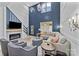 Bright living room boasts a cozy fireplace and soaring ceilings with elegant chandelier at 8123 Village Harbor Dr, Cornelius, NC 28031