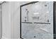 Walk-in shower featuring marble-look tile and dual shower heads at 8123 Village Harbor Dr, Cornelius, NC 28031