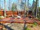 Backyard deck featuring comfortable seating around a faux stone fire pit at 9331 Hanworth Trace Dr, Charlotte, NC 28277