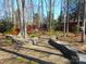 Beautiful backyard landscaping with a stone-lined walkway and a seating area with chairs at 9331 Hanworth Trace Dr, Charlotte, NC 28277