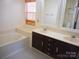 Bathroom with double vanity, tub, and natural light at 9331 Hanworth Trace Dr, Charlotte, NC 28277