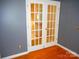 Hallway features double glass doors, wood flooring and neutral paint, creating an inviting transition between rooms at 9331 Hanworth Trace Dr, Charlotte, NC 28277