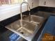 Stainless kitchen sink with updated faucet and black counters at 9331 Hanworth Trace Dr, Charlotte, NC 28277